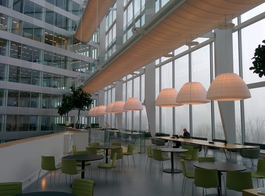 pexels-photo-260931 Contemporary office interior with large windows and stylish furniture, featuring a foggy exterior view.